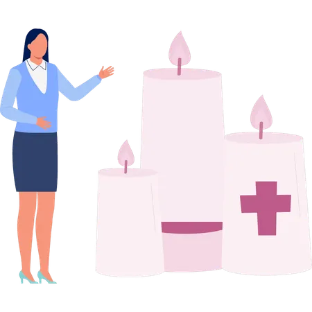 Une femme pointe une bougie allumée  Illustration